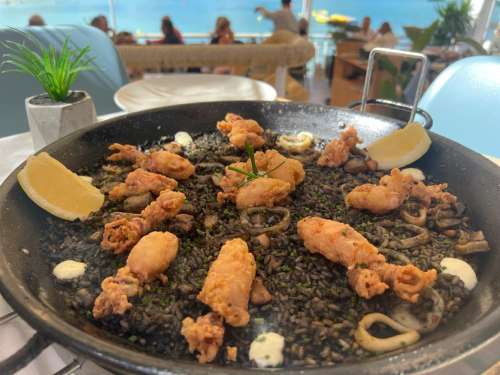 paella history with a picture of the dish